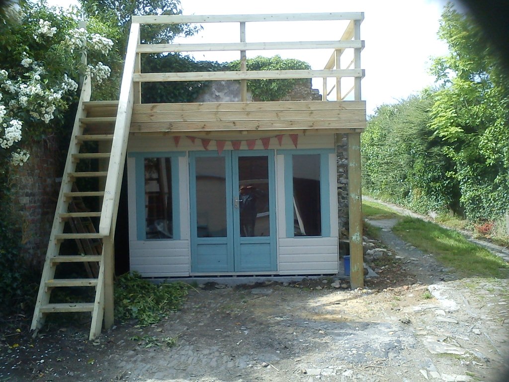 Summer house with decking above.